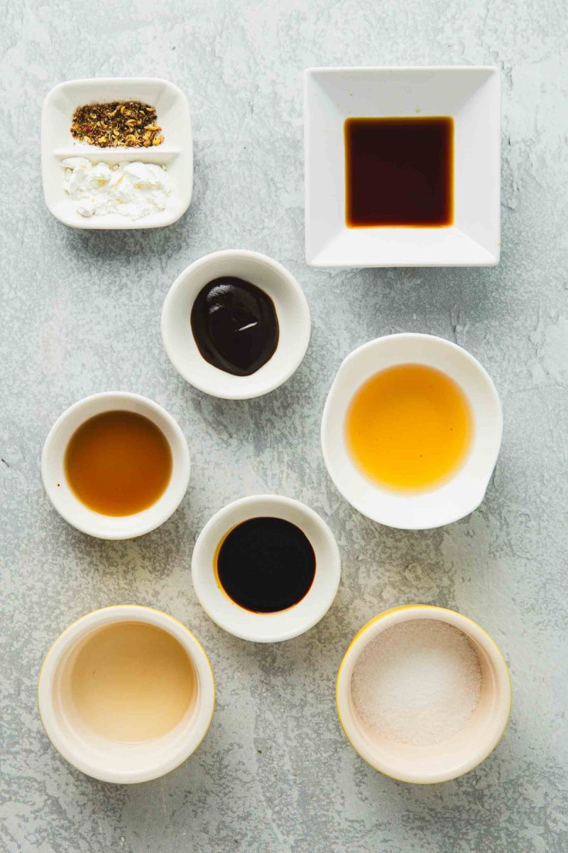 A variety of kung pao beef sauces and seasonings in small bowls.