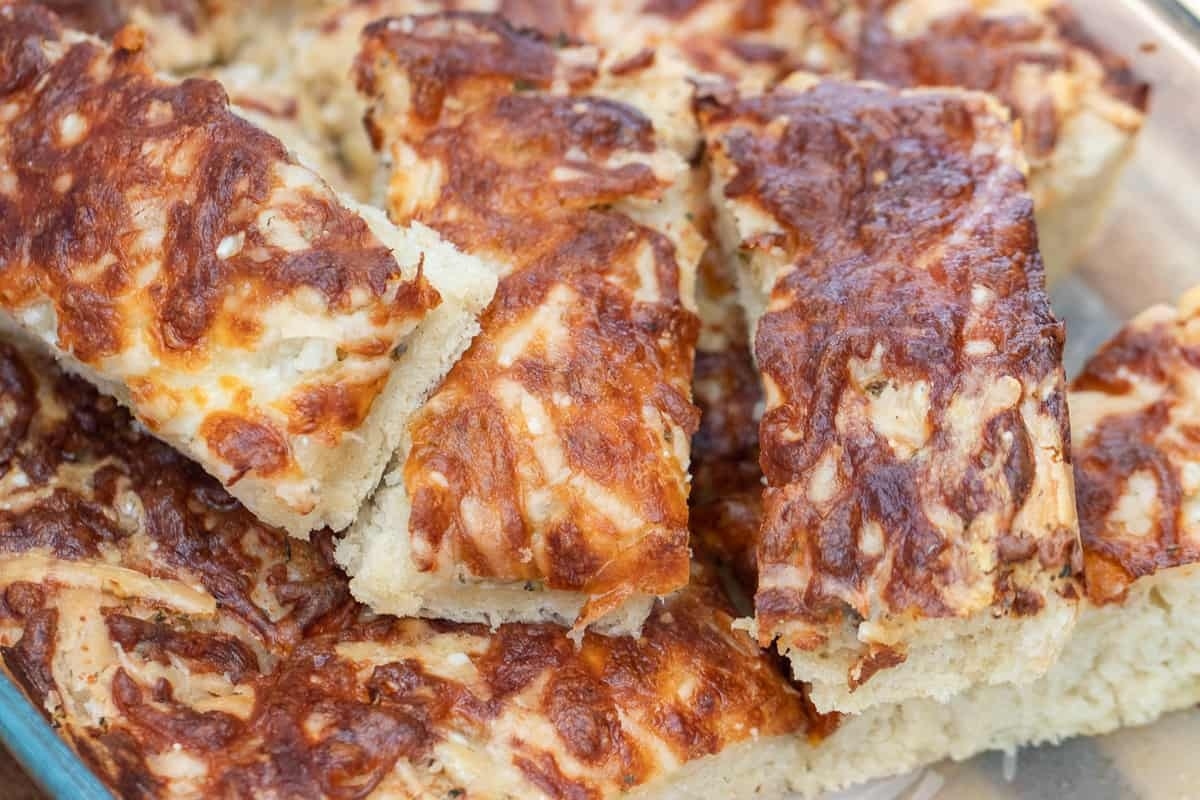 A slice of cheese bread in a glass dish.