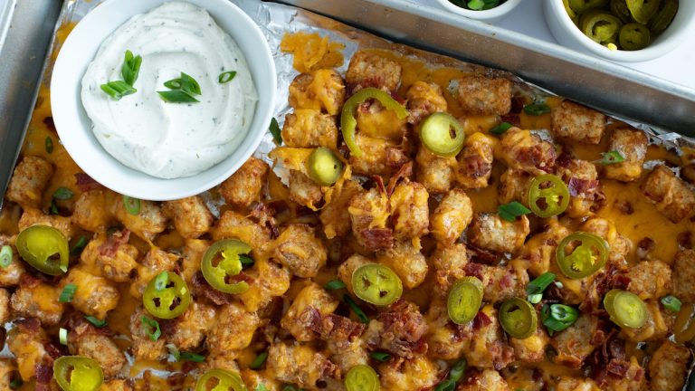 A tray of loaded tater tots with cheese, bacon and jalapenos.