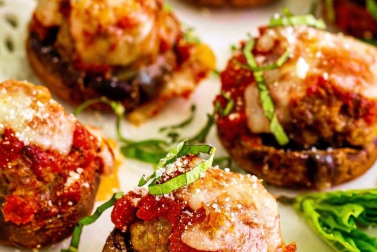Meatball stuffed mushrooms on a plate.
