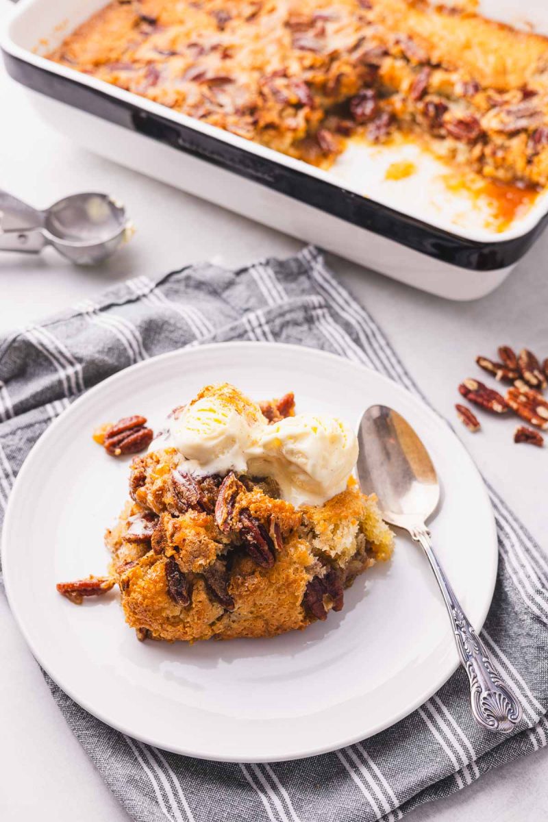 A plate with a slice of pecan cobbler on it.