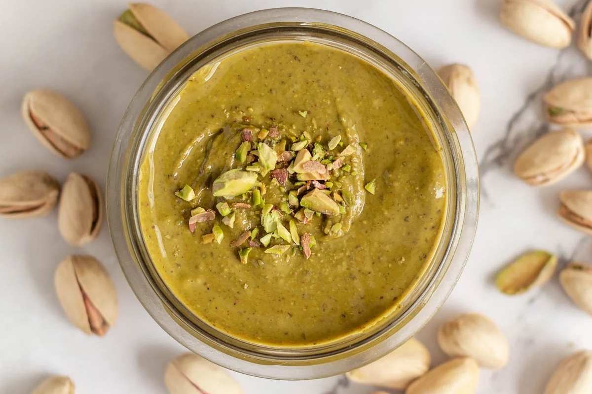 A bowl with pistachios and pistachios in it.