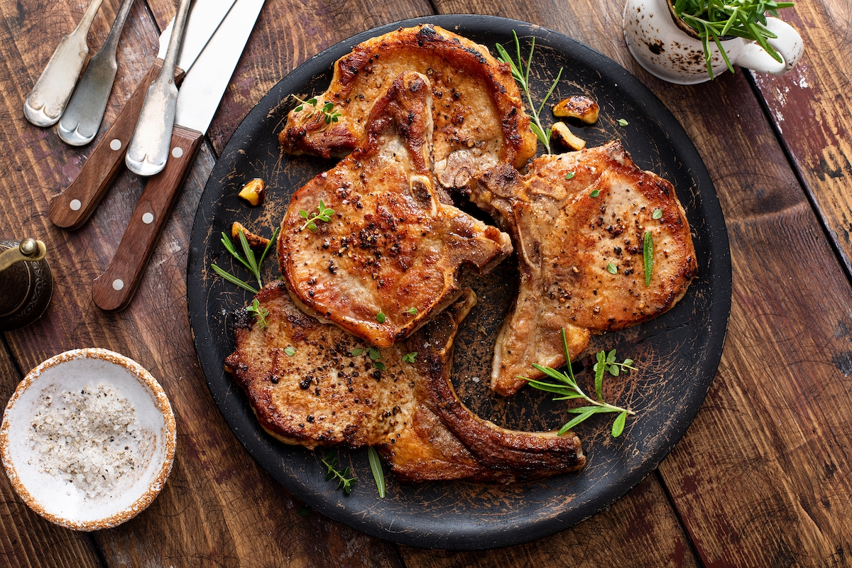 Grilled or pan fried pork chops on the bone with garlic and rosemary.