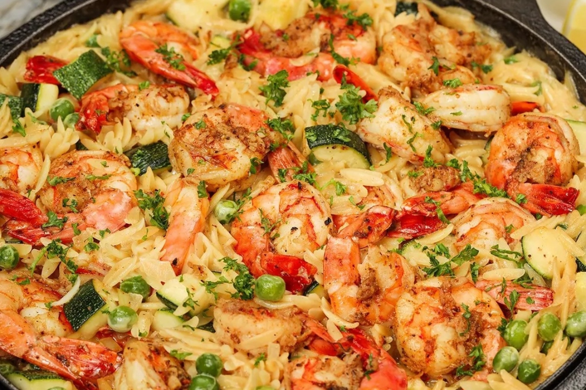 Shrimp and pasta in a skillet.