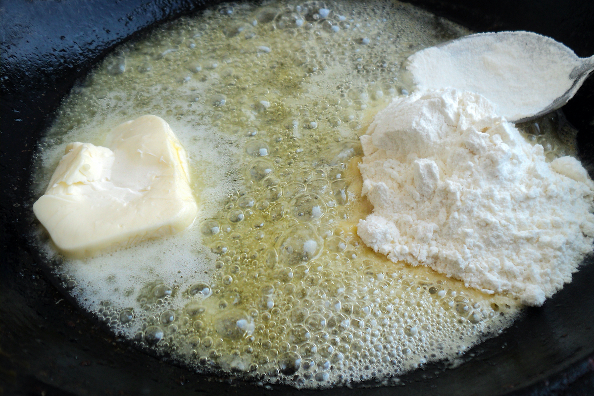 Classic bechamel sauce cooking process. Butter and flour in a pan.