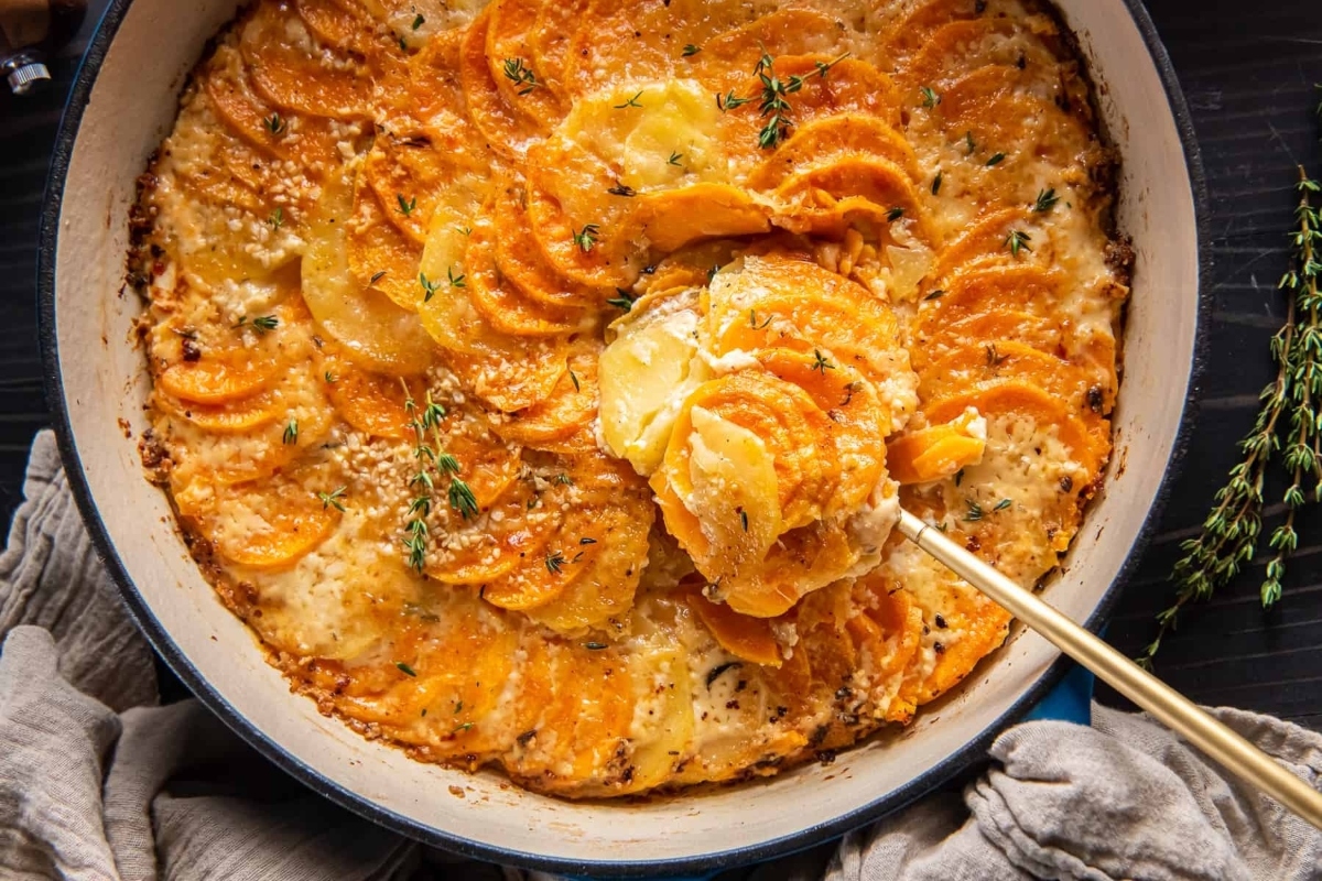 Sweet potato casserole in a dish with a spoon.