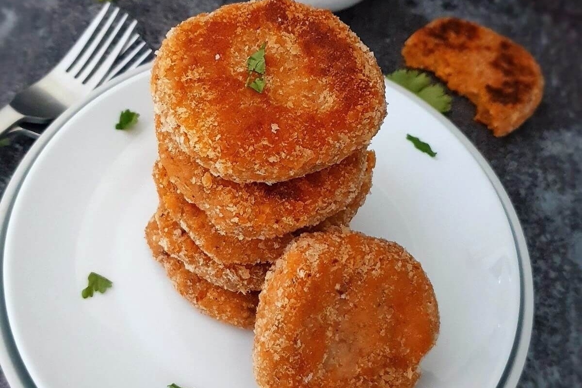A stack of fried sweet potato patties on a plate.