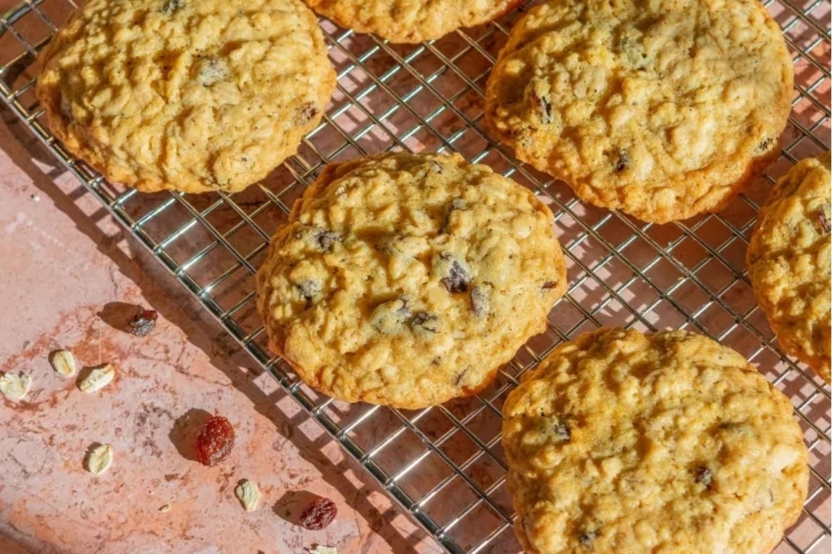 Oatmeal raisin cookies on a cooling rack.