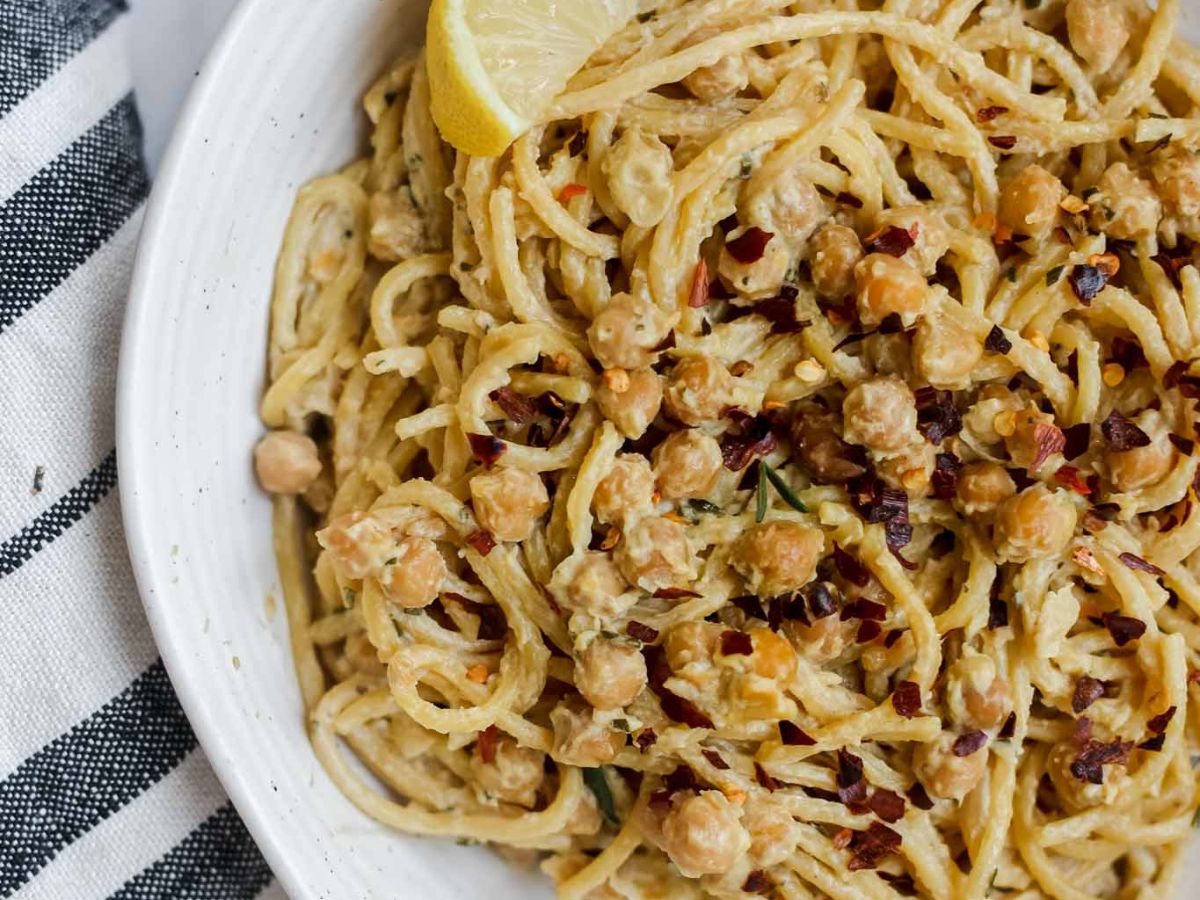 Bowl of pasta with chickpeas and napkin on the side.