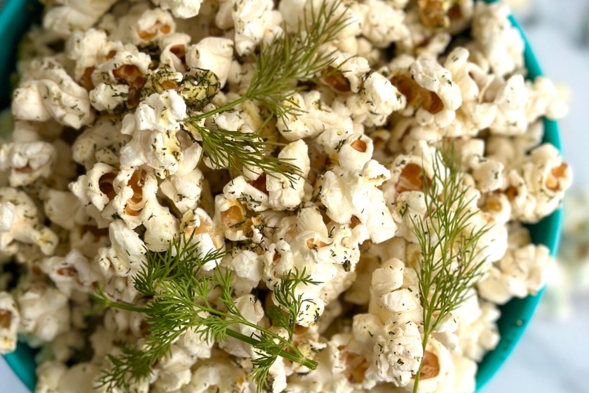 A bowl of popcorn with dill.