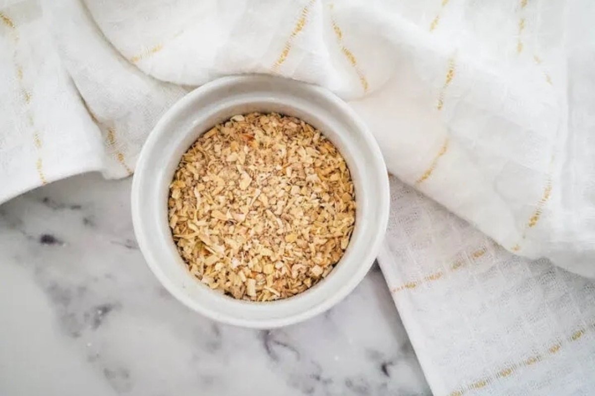 Granola in a bowl on top of a white towel.