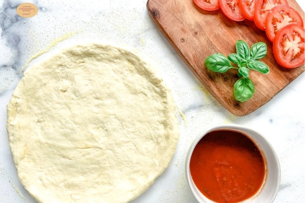 A pizza dough and tomato sauce.