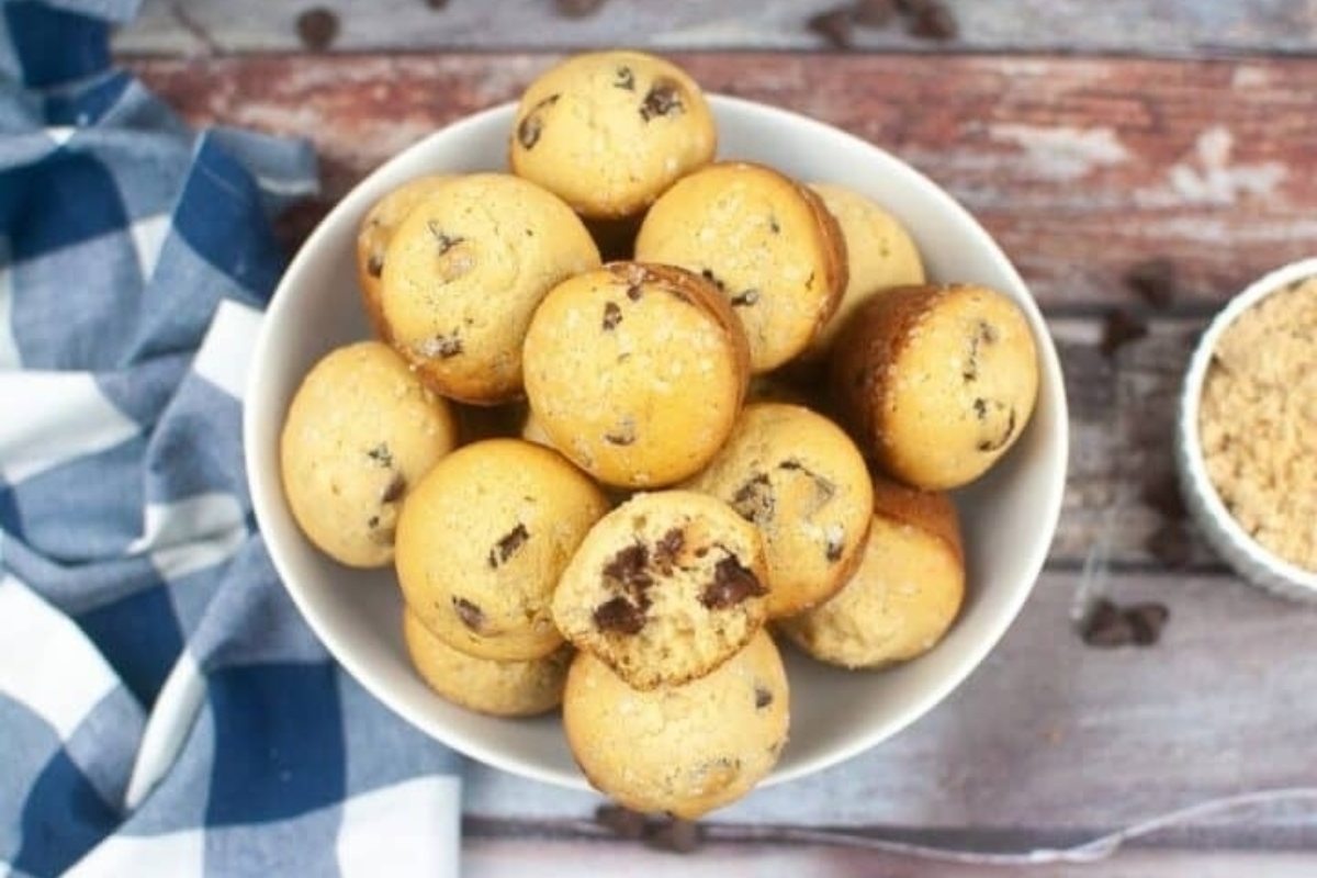 A bowl of muffins on a table.