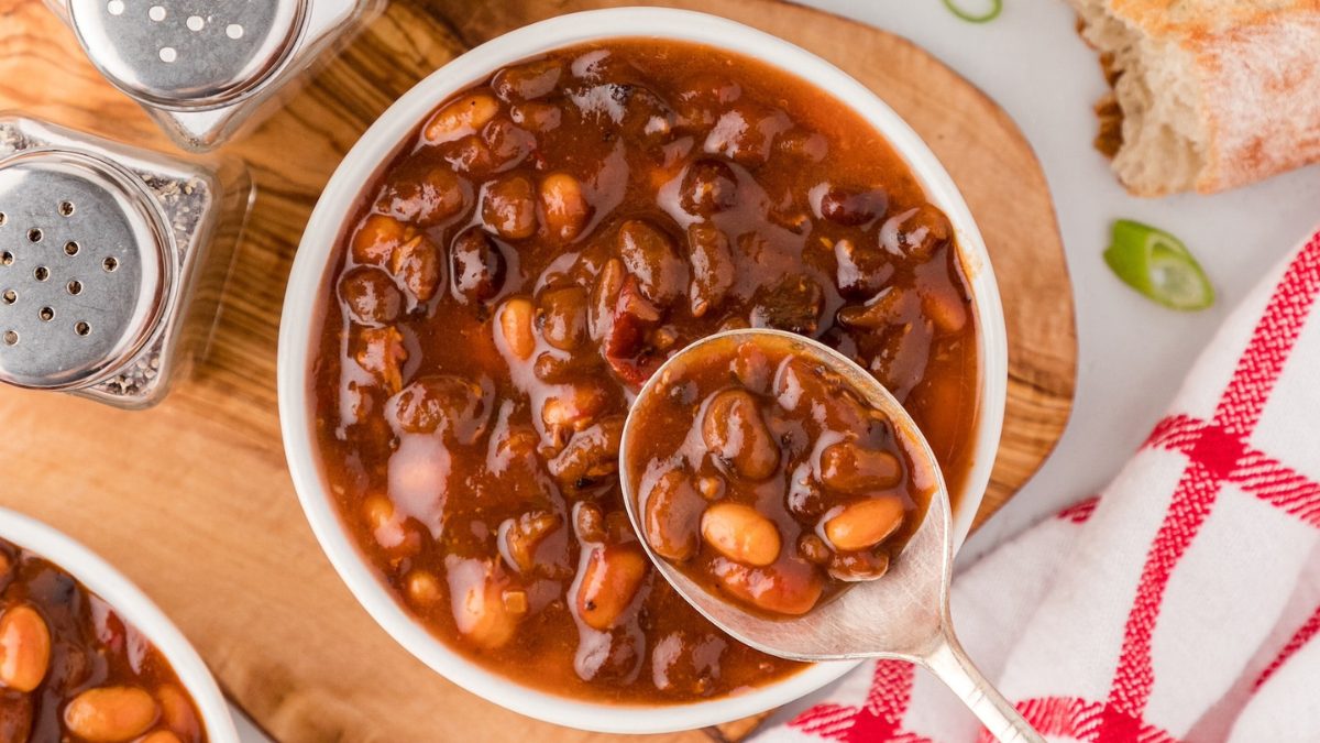 BBQ bacon baked beans in a white bowl.