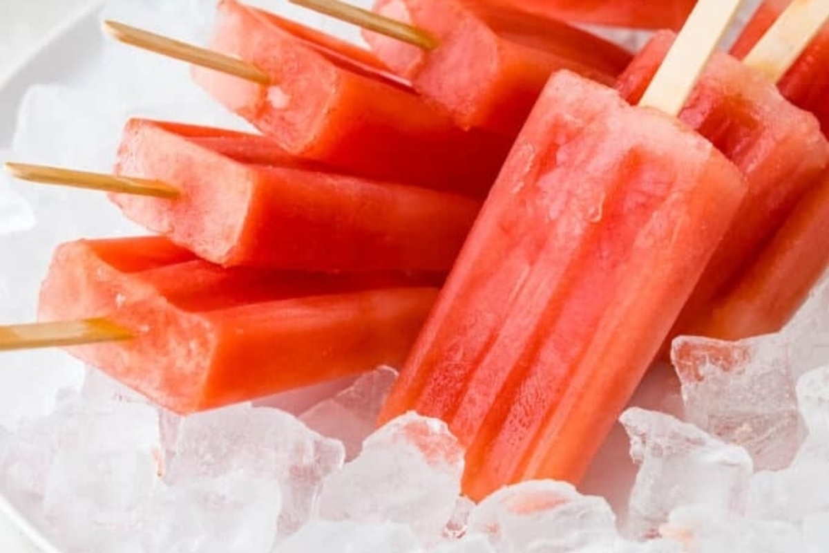 Watermelon popsicles with ice on a plate.