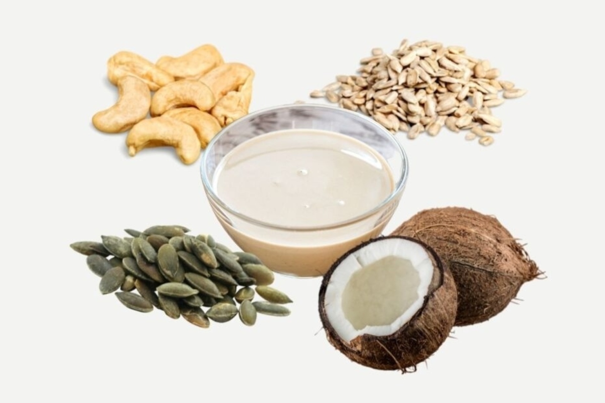 A glass of milk, nuts, seeds and cashews.