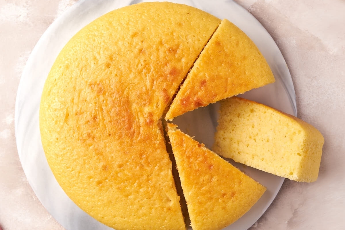 A slice of yellow cake on a plate.