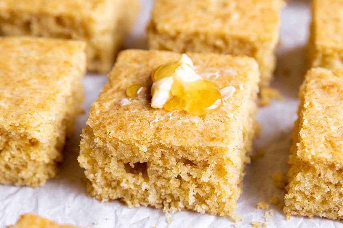 Squares of cornbread with honey on top.