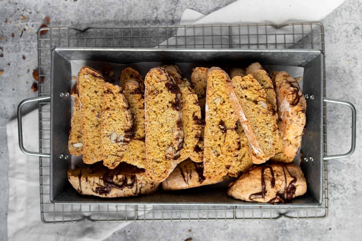 A tray of cookies with chocolate drizzled on top.