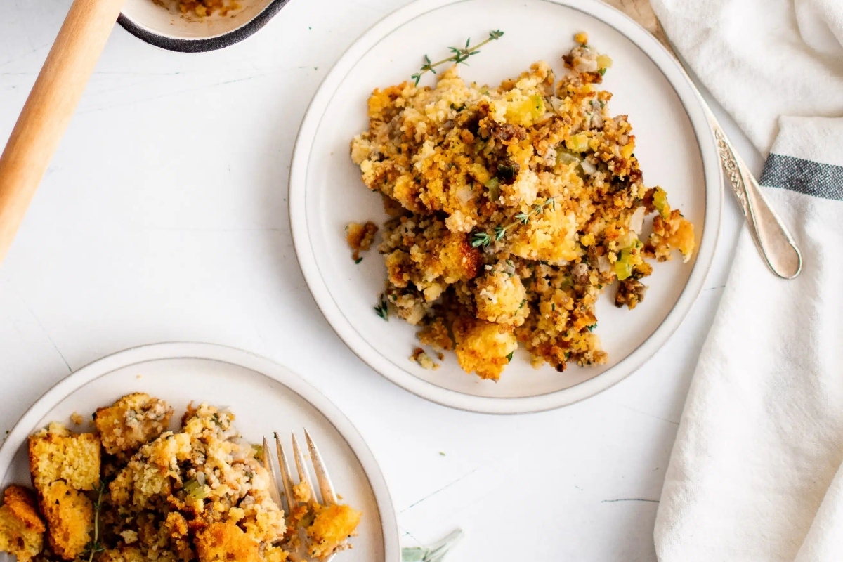 A plate of traditional stuffing garnished with fresh herbs.