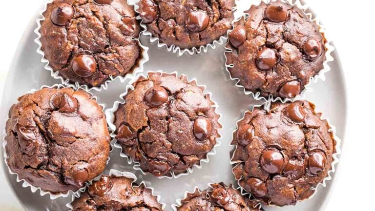 Chocolate chip muffins on a white plate.