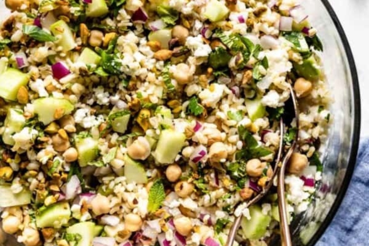 A bowl of chickpea salad with cucumbers and chickpeas.