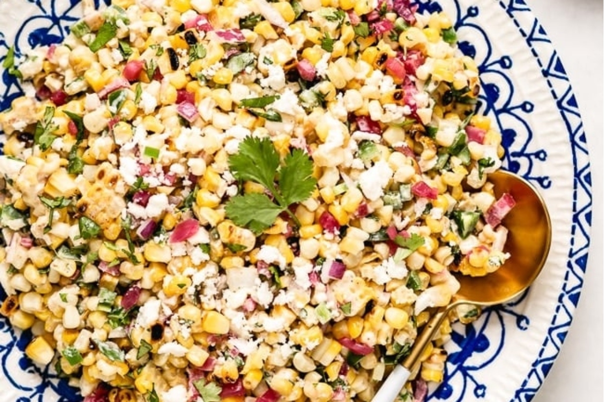 Mexican corn salad on a blue and white plate.