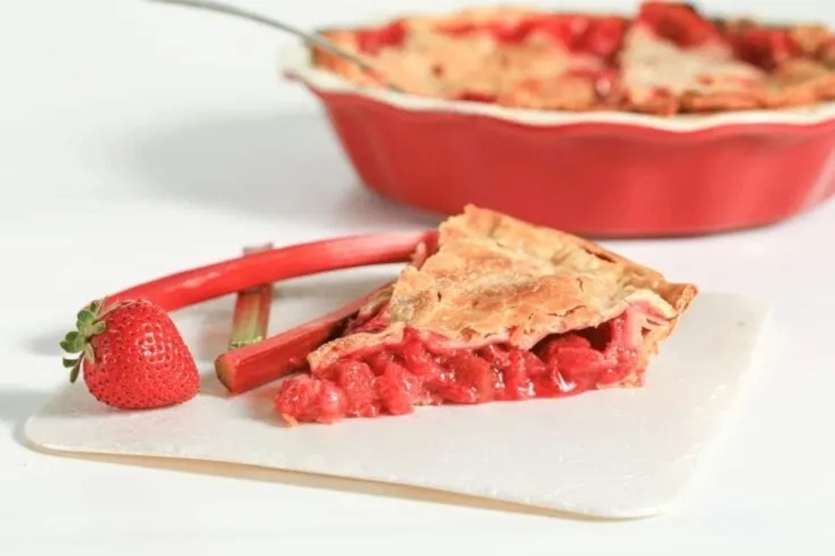 A slice of strawberry pie on a white plate.