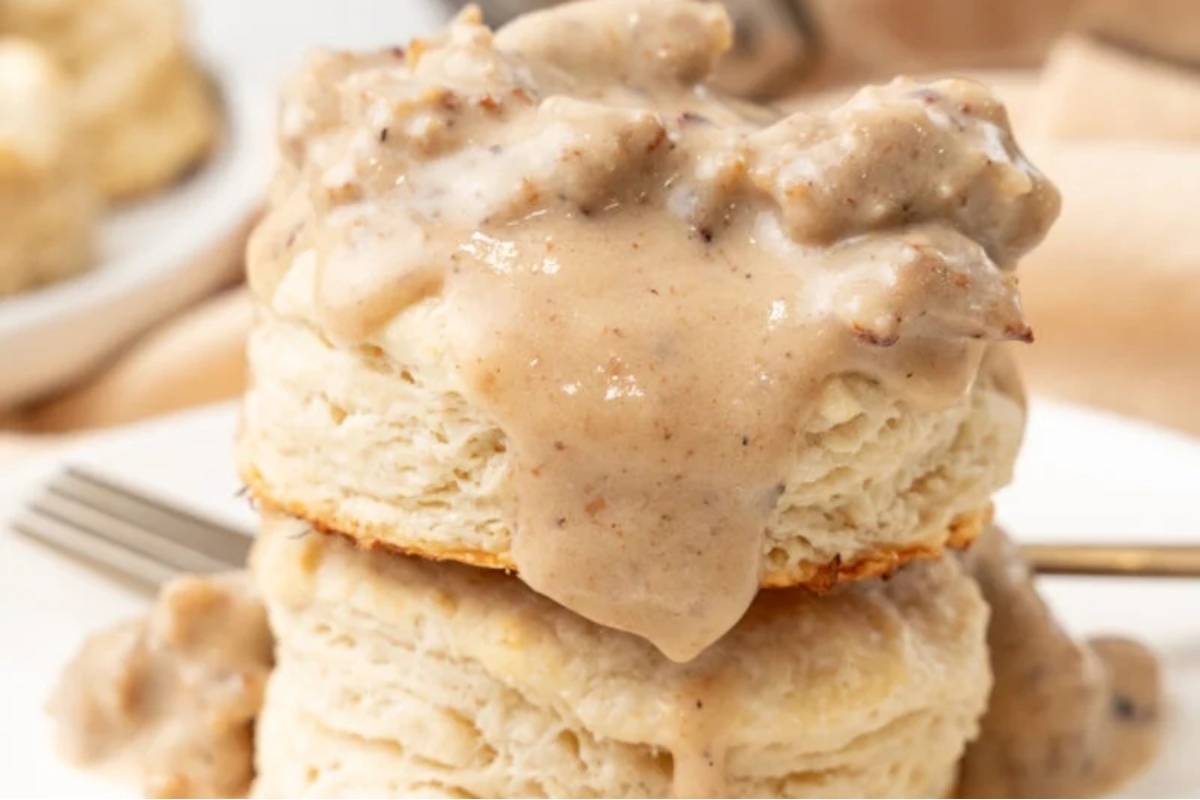 A stack of biscuits topped with creamy sausage gravy.