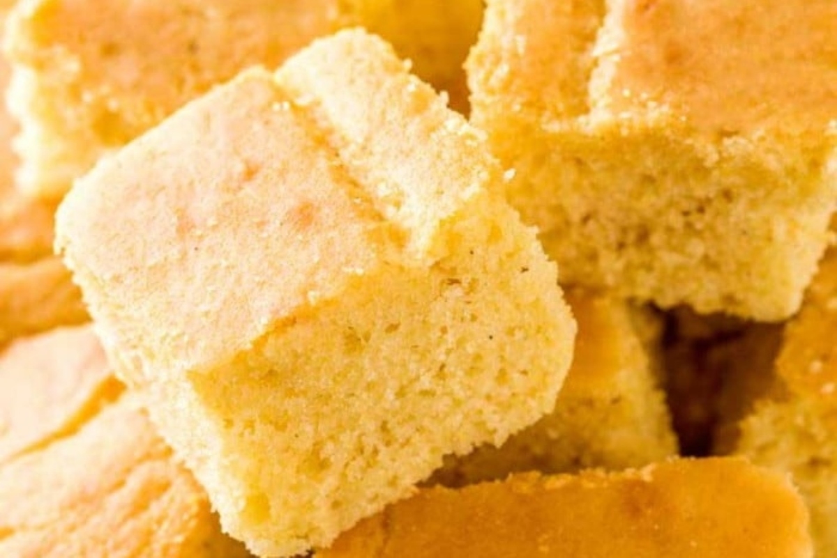 Freshly baked, golden-brown cornbread squares arranged closely.