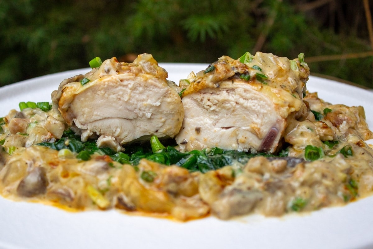 A plate of food with a couple pieces of chicken.