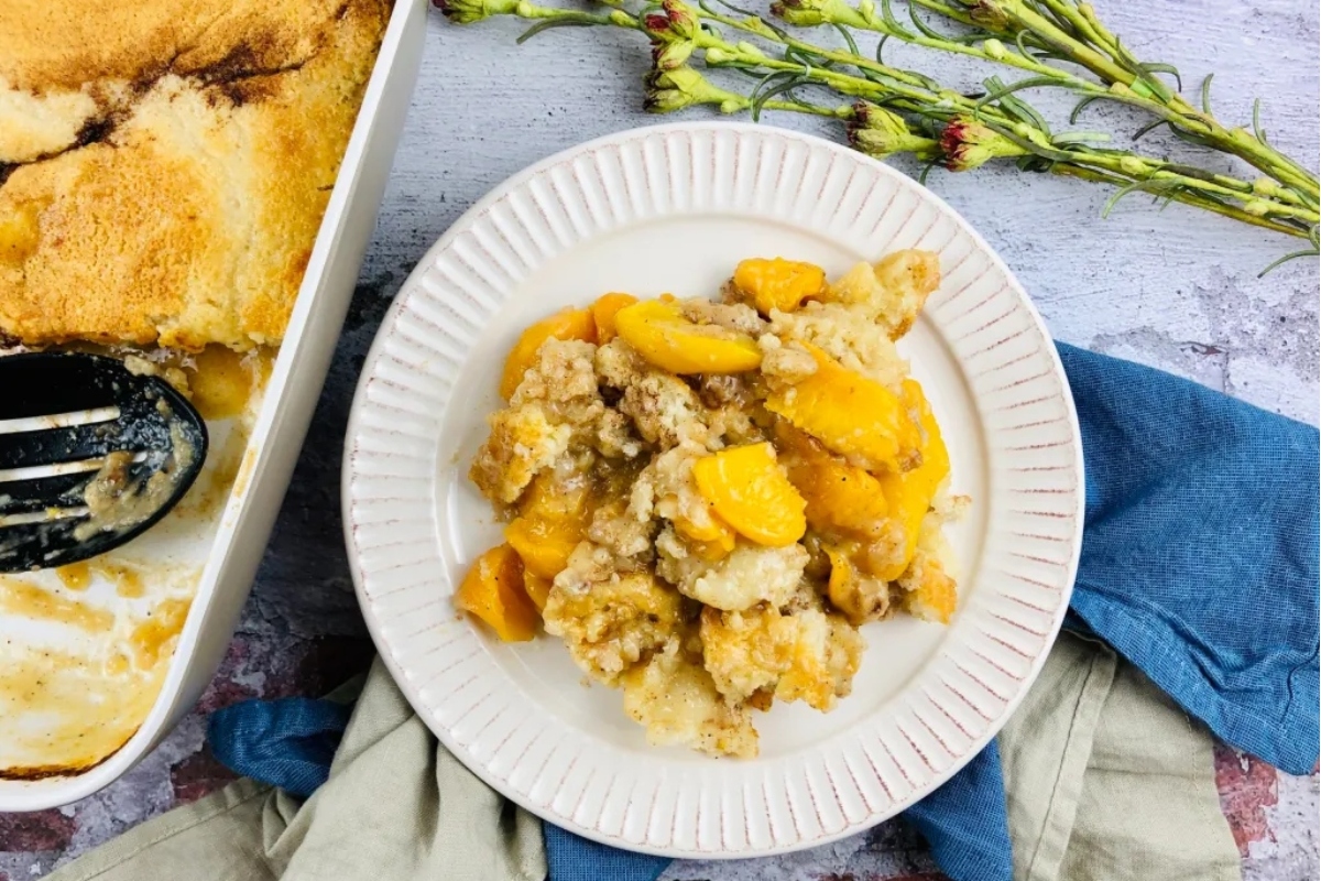 Peach cobbler on a plate with a fork.