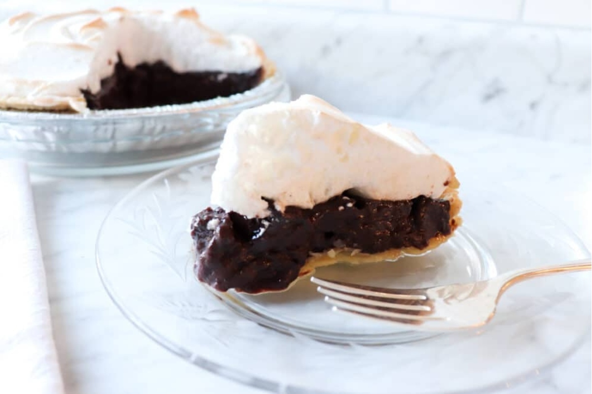 A slice of chocolate meringue pie on a plate.