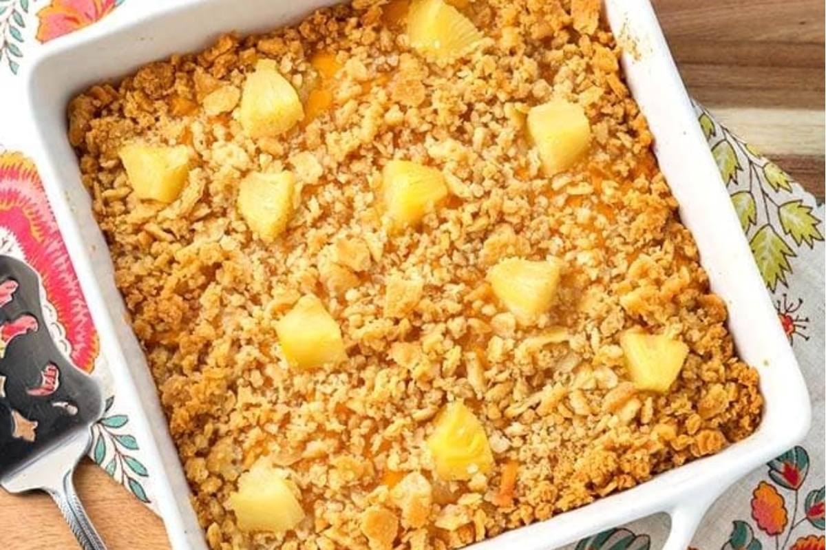 Baked pineapple crumble in a decorative dish.