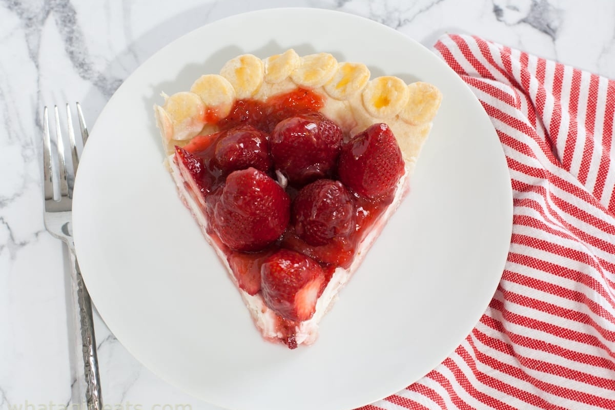A slice of strawberry pie on a white plate.
