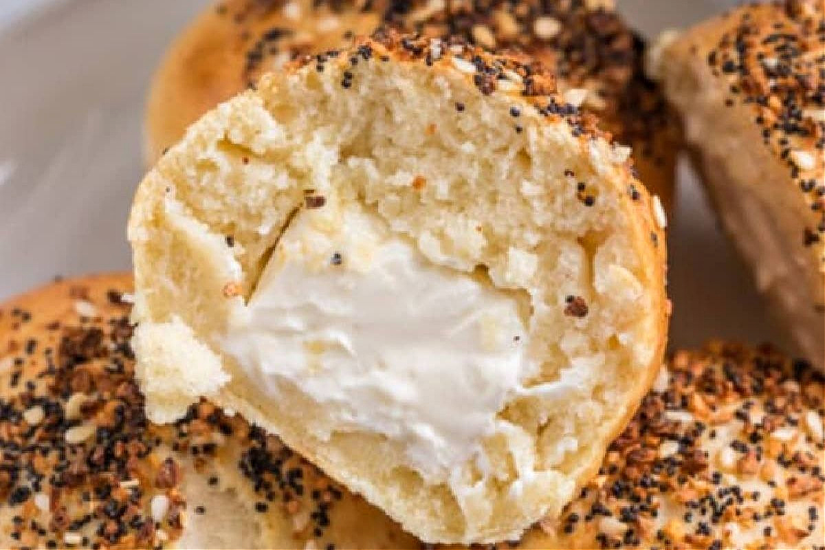 A bagel bite sliced in half with cream cheese inside.