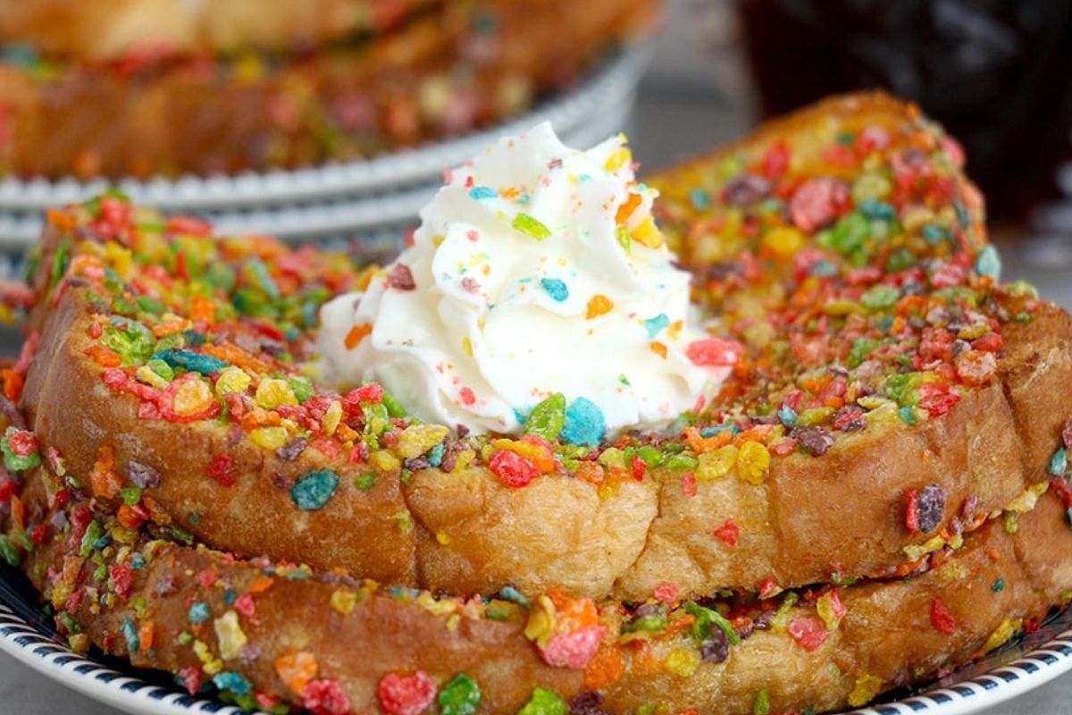Two slices on a plate with whipped cream.