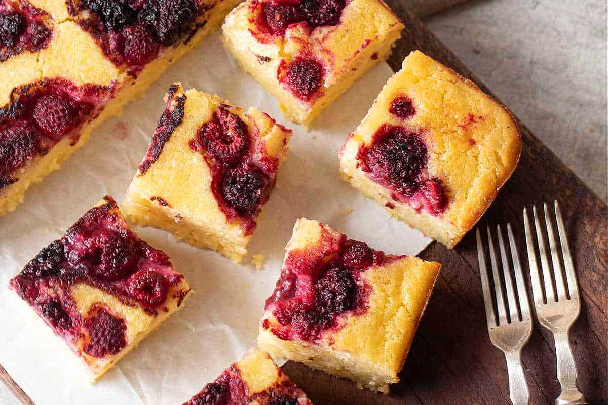 Berry ricotta cake squares on wooden board 1