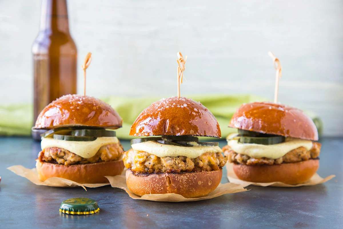 Ground Pork Sliders With Mustard Cream And Quick Pickled Cucumbers.
