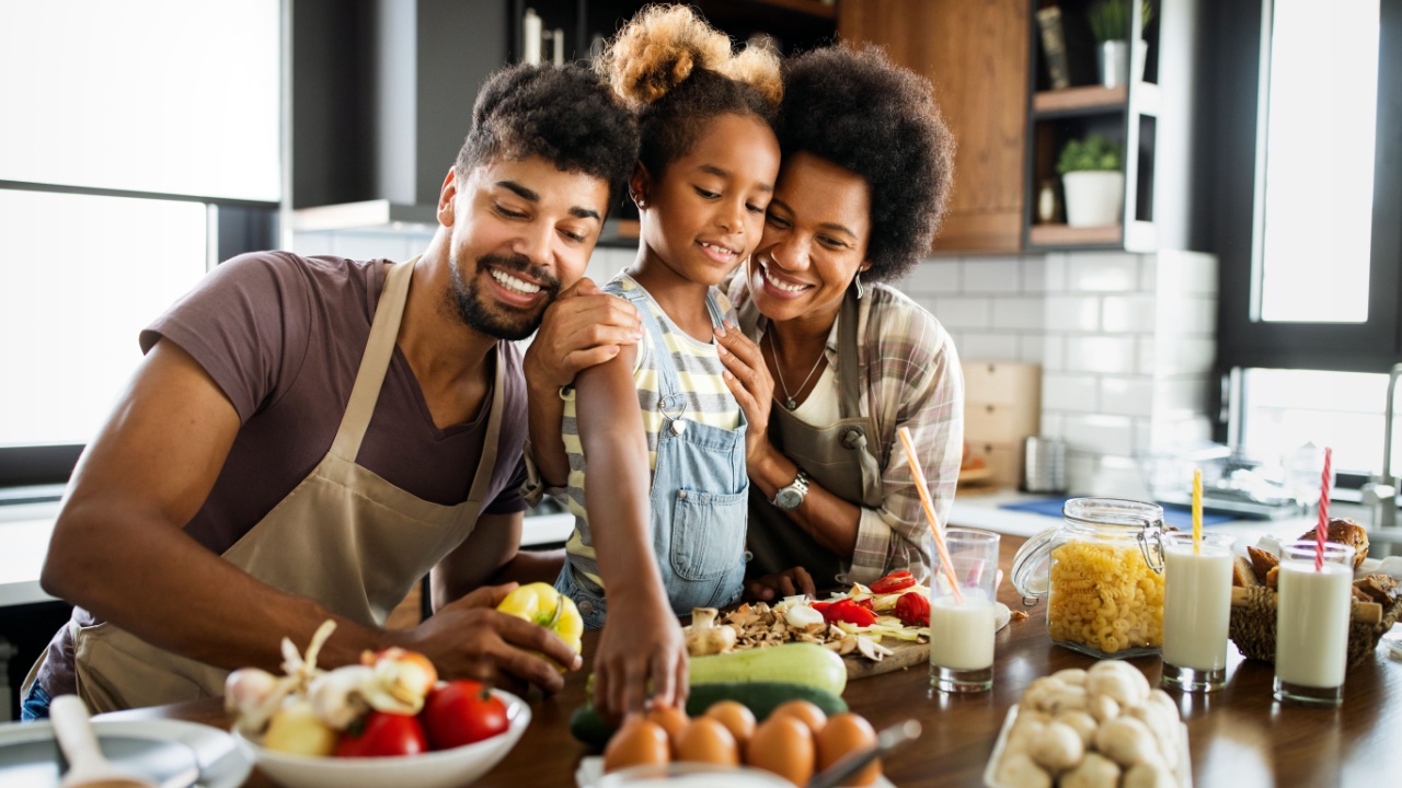 Happy family having fun together at home in the kitchen cooking