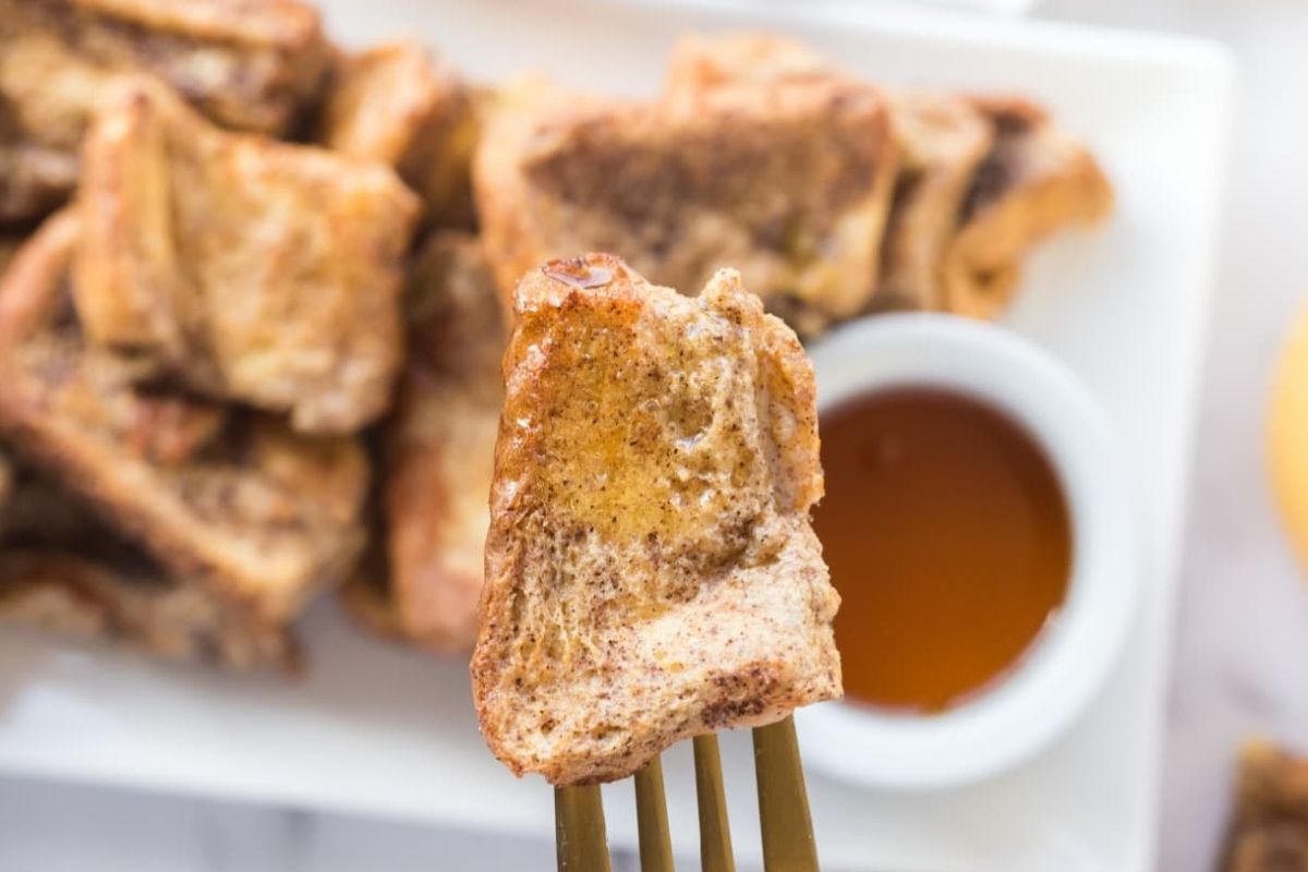 A piece of french toast on a fork.