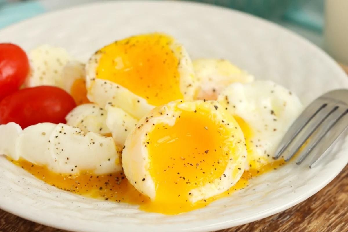Soft boiled eggs on a white plate.