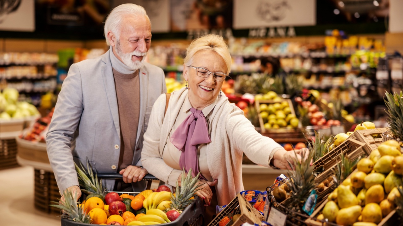 couple buying fruit in grocery store